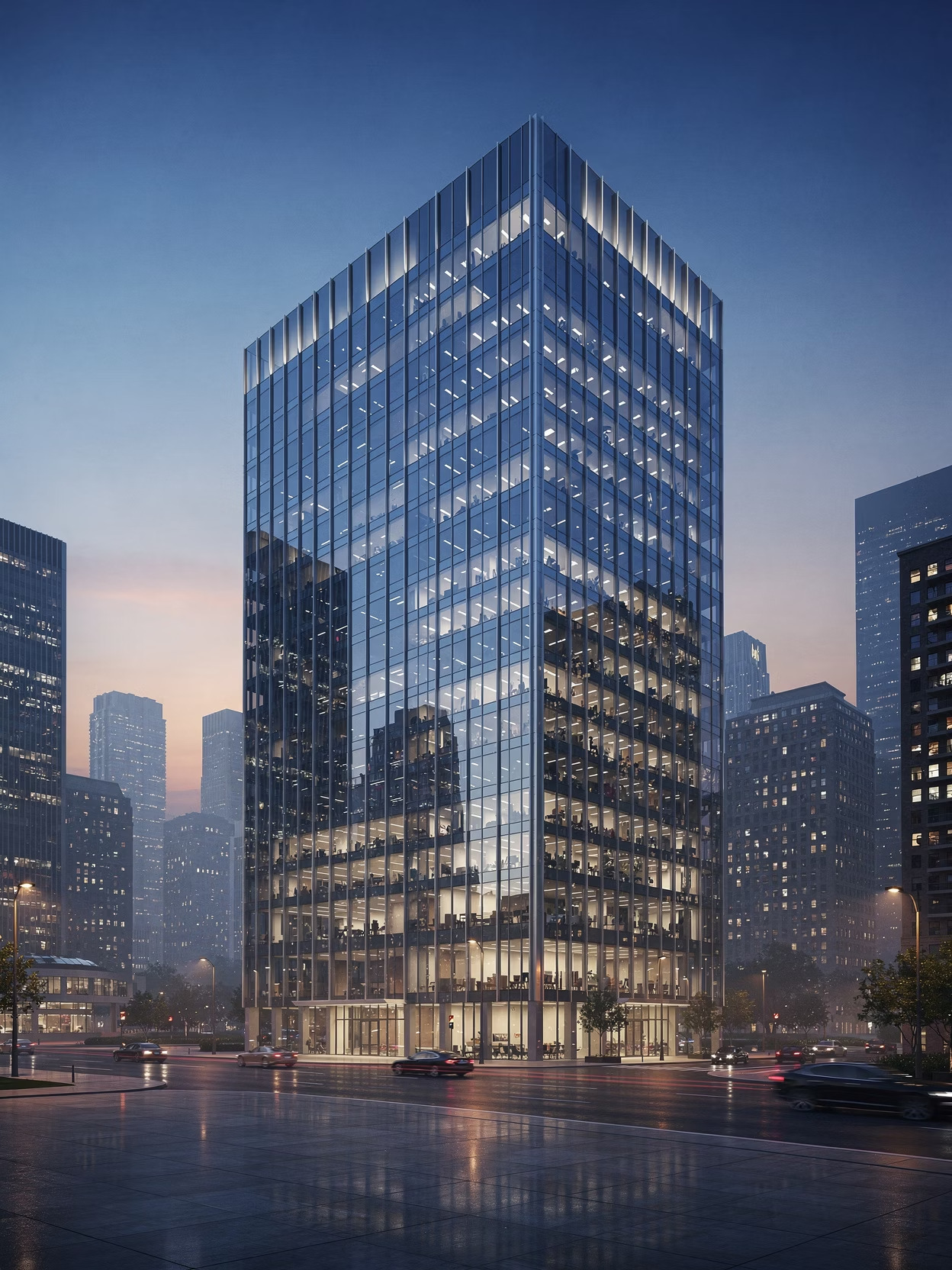 Modern glass office building lit up at dusk in a city skyline